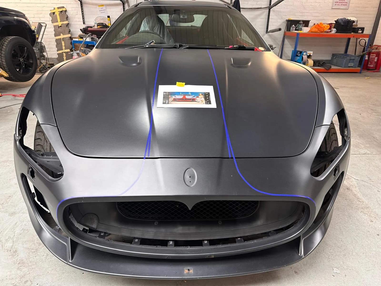 Front end of a sports car during detailing and assembly work