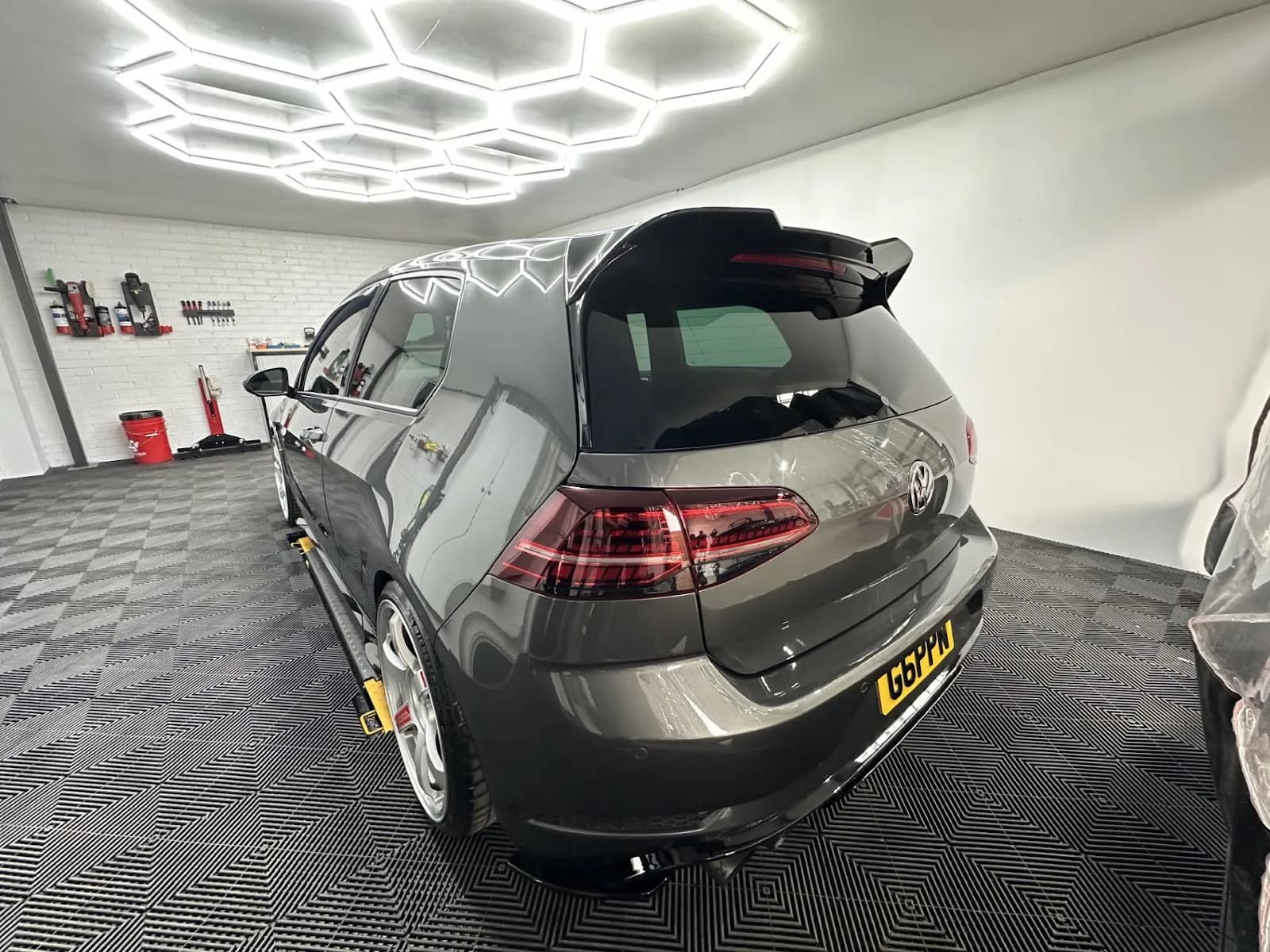 Grey performance car inside the Lusso Auto Care workshop